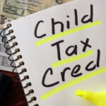 Notebook with child tax credit sign on a table.
